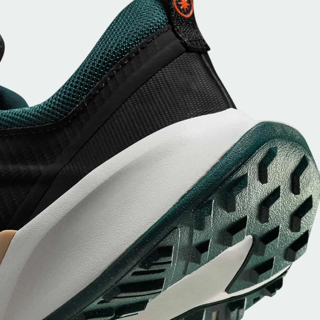 Detailed zoom on the outsole and midsole of the Nike Juniper Trail 2 Women's trail shoes, highlighting the cushioned foam and rugged rubber outsole.