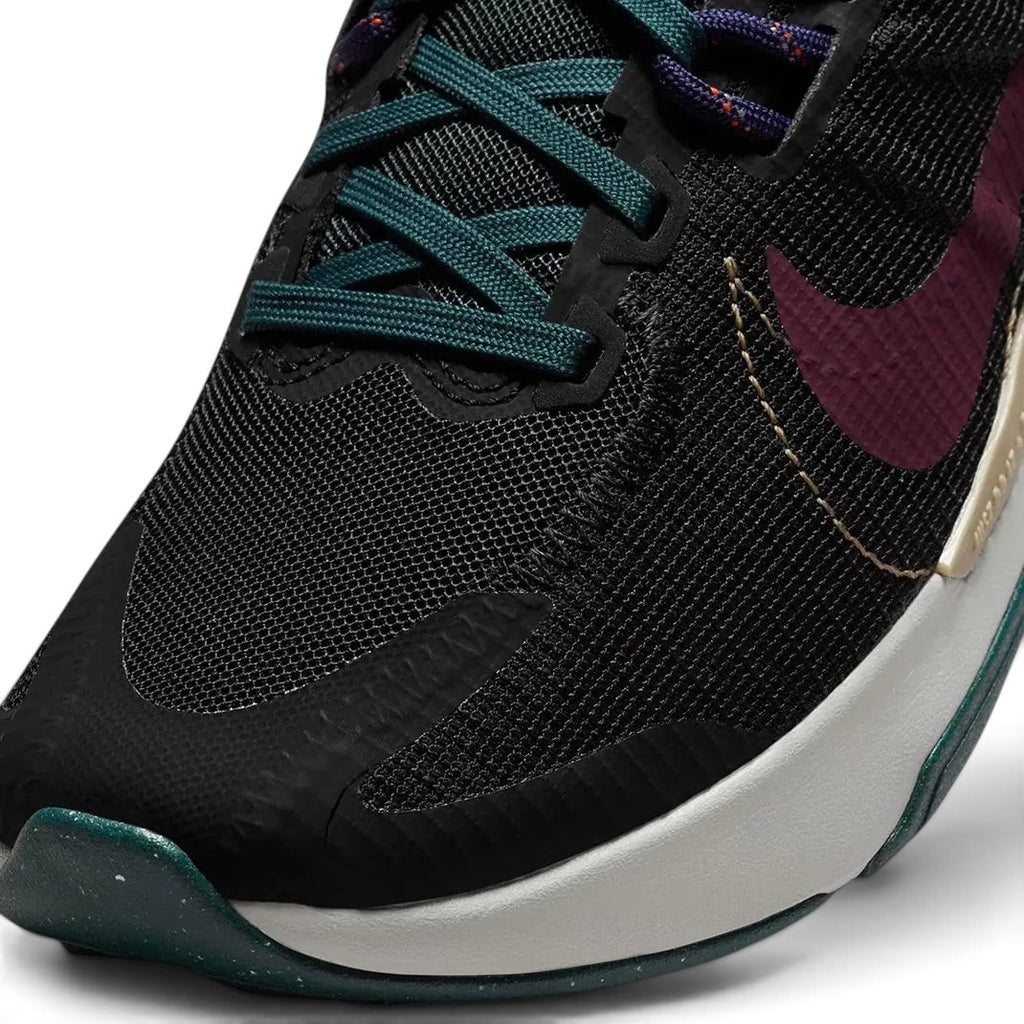 Close-up zoom on the front of the Nike Juniper Trail 2 Women's trail shoes, showing the reinforced toe cap, mesh upper texture, and lacing system.