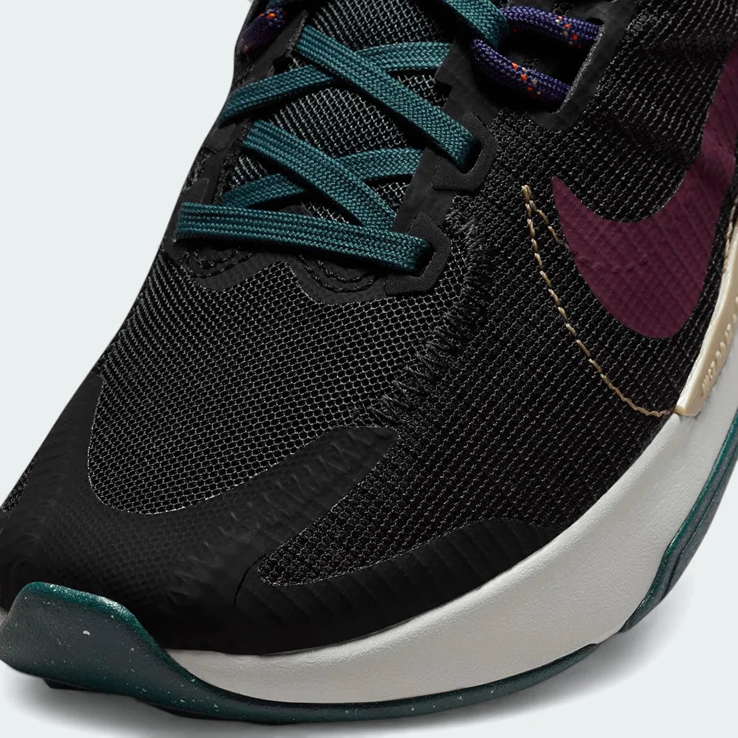 Close-up zoom on the front of the Nike Juniper Trail 2 Women's trail shoes, showing the reinforced toe cap, mesh upper texture, and lacing system.