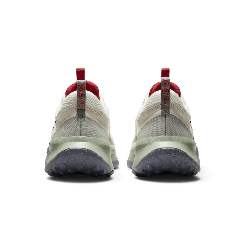 Focuses on the rear profile, highlighting the padded off-white heel collars, grey webbing pull tabs with circular trail icons, and the wide flared base of the sage green midsole and lugged rubber outsole.