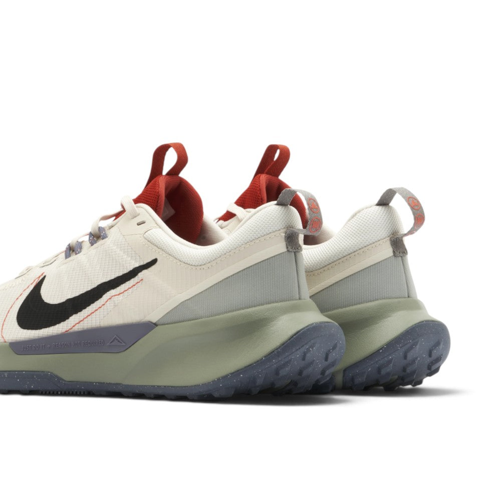 Highlights the three-quarter rear profile showcasing the elevated red tongue pull loop, supportive ripstop heel counter, speckled grey midsole clip, and curved dark outsole tread wrap.