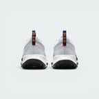 Focuses on the rear profile, highlighting the maroon heel pull loops stamped with reflective trail icons and the sturdy white foam heel flare.