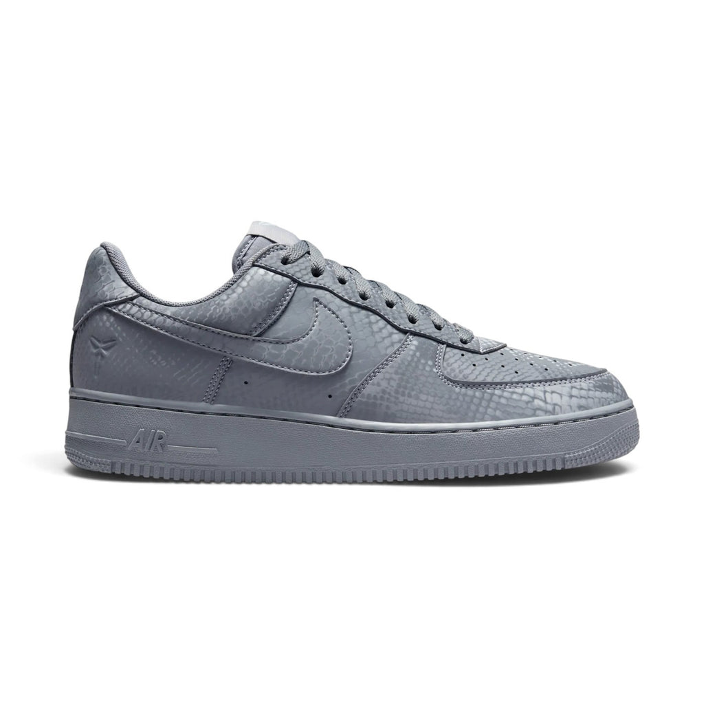 Displays the full lateral silhouette featuring the smooth cool grey and wolf grey leather upper, perforated toe box, tonal side Swoosh overlay, thick matching grey foam midsole with embossed "AIR" lettering, and durable rubber outsole.