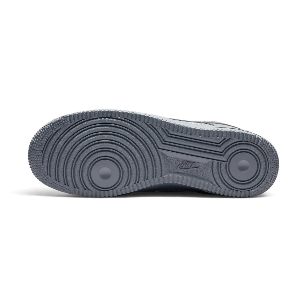 Full-length bottom profile showing the monochromatic grey rubber outsole, highlighting the iconic concentric pivot circles under the forefoot and heel, along with recessed Nike branding at the midfoot arch.