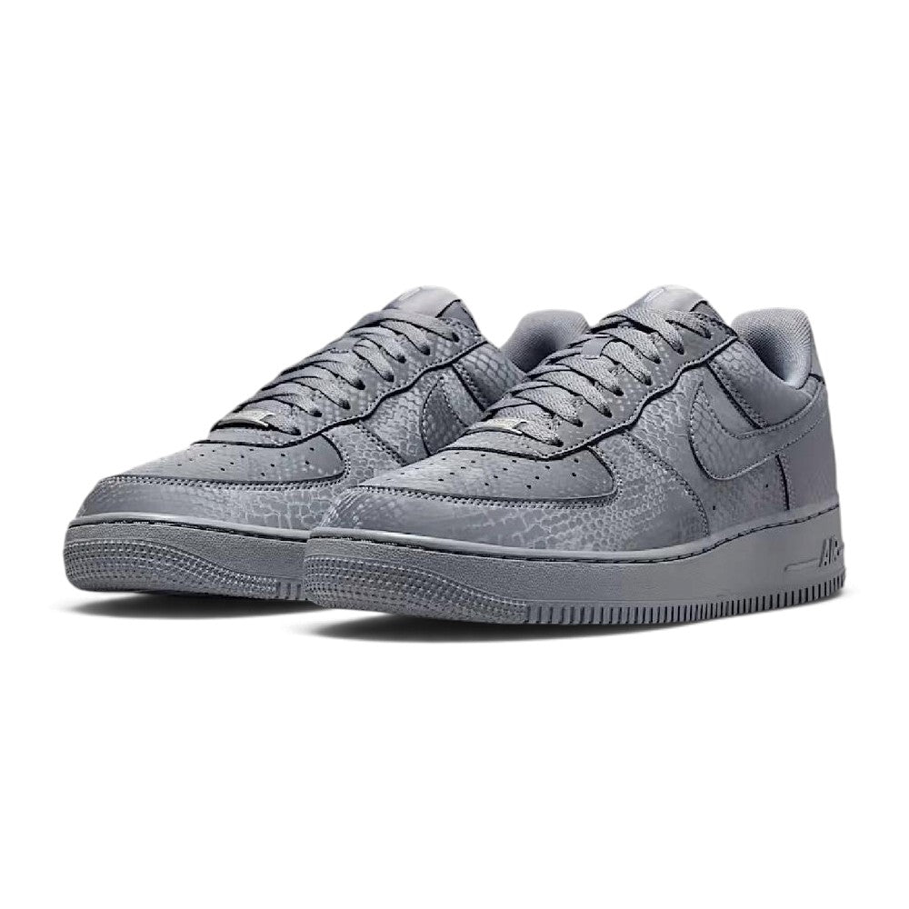 Forward three-quarter angle showcasing both shoes side by side, highlighting the classic low-top basketball stance, premium leather sheen, tonal grey colourway, and sturdy cupsole construction.
