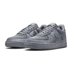 Forward three-quarter angle showcasing both shoes side by side, highlighting the classic low-top basketball stance, premium leather sheen, tonal grey colourway, and sturdy cupsole construction.