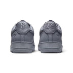 Close-up rear angle focusing on the supportive grey leather heel tab with signature Kobe markings, the upper heel stitching, and the clean rear wrap of the foam midsole.