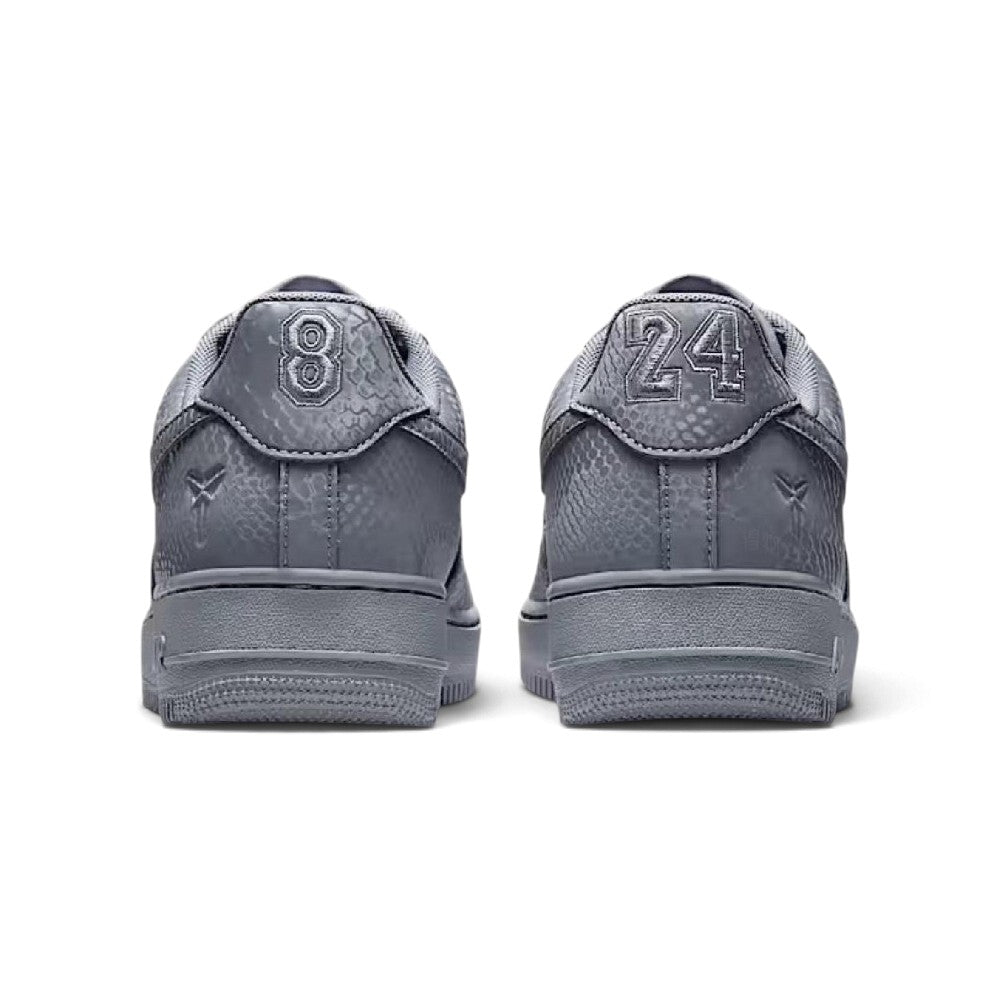 Close-up rear angle focusing on the supportive grey leather heel tab with signature Kobe markings, the upper heel stitching, and the clean rear wrap of the foam midsole.