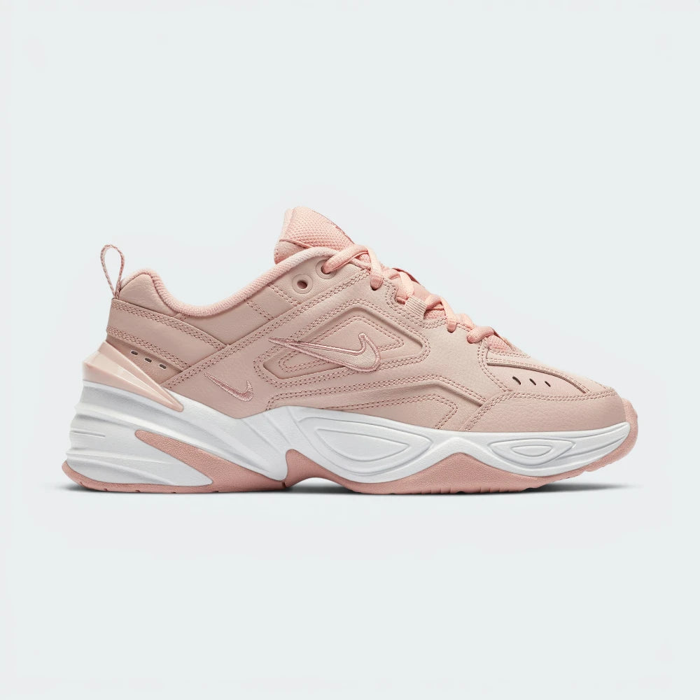 Highlights the high-velocity sweep of the clean tonal beige mini Nike Swoosh, showing the professional, multi-layered texture of the Particle Beige leather panels resting above the chunky, distorted lines of the thick beige foam midsole wall.