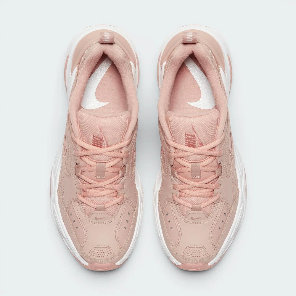 Focuses on the locked-in traditional lacing layout, displaying the perfect symmetry of the beige textile tongue, the debossed branding accents, and the clean stitching lines tracking down the leather front toe box area.