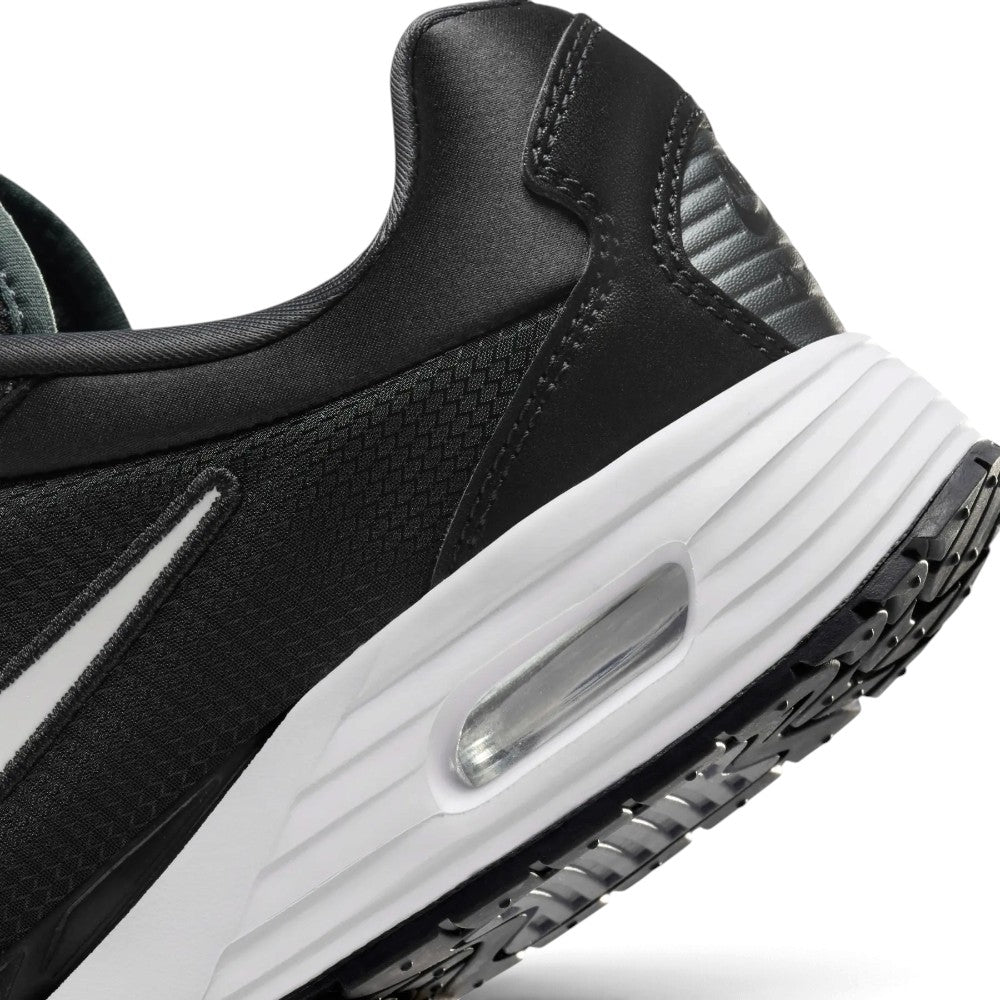Macro view of the lateral heel transition, highlighting the clean cellular structure of the visible Max Air window and the durable rubber tread grip wrap.
