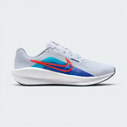 Highlights the high-velocity sweep of the Blue Lightning Nike Swoosh, showing the professional, texturized weave of the Football Grey mesh upper resting above the thick, angular soft white foam midsole wall with pops of Bright Crimson.