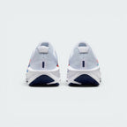 Focuses on the contoured shape of the padded ankle collar, highlighting the clean structural sweep of the rear foam wedge and the Bright Crimson inner fabric lining peaking over the rim.