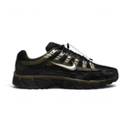 Highlights the lateral profile featuring a metallic silver Nike Swoosh with gold-khaki trim, showing the black mesh upper, olive-green Cargo Khaki overlays, silver reflective accents, speed-cord toggle lacing, and the dark foam midsole.
