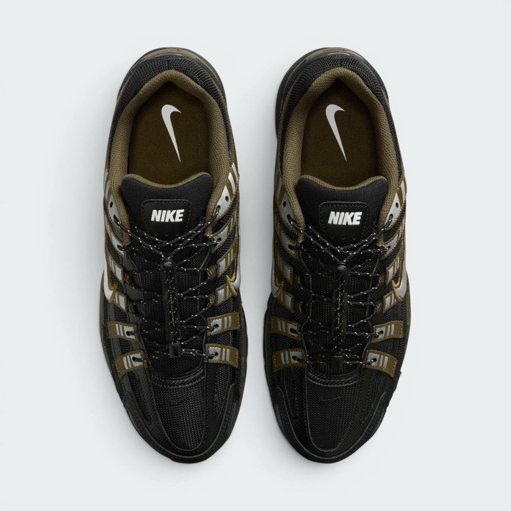 Focuses on the locked-in toggle lacing layout, displaying the flecked speed laces with cinch lock, central "BOWERMAN SERIES" ribbon, black mesh tongues, and khaki-lined interior footbeds with white Swoosh logos.