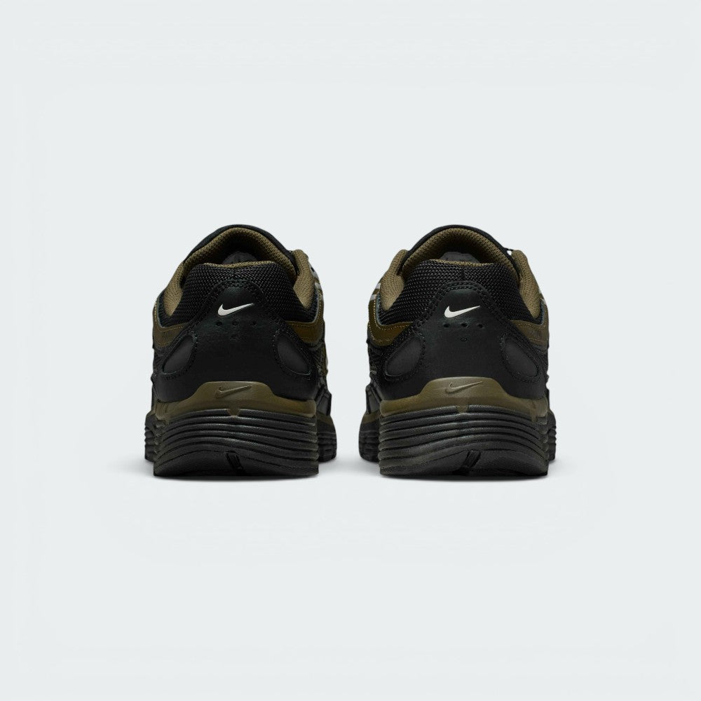 Focuses on the rear profile, highlighting the black synthetic heel counters with white micro-Swoosh logos, Cargo Khaki frame, and the wide black foam midsole base.