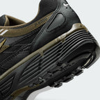 Highlights the "unreal" clean finish where the grooved dark foam midsole meets the black rubber outsole tread, displaying the debossed "P-6000" collar badge and olive heel clip.