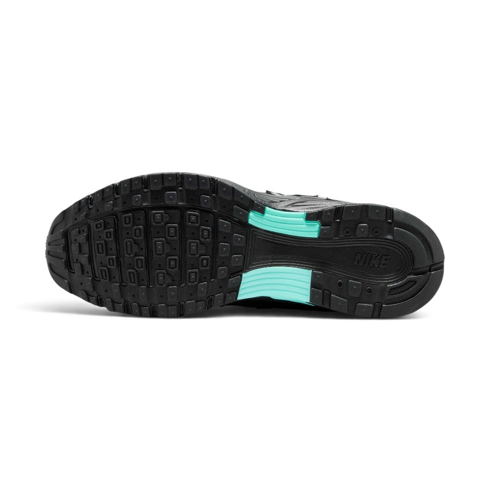 Focusing on the durable full-length black rubber outsole featuring waffle-inspired lug segments, forefoot flex grooves, turquoise midfoot shank accents, and Pegasus-inspired traction pods, showcasing the grip matrix engineered for a successful tackle of city pavements, tarmac, and indoor flooring.