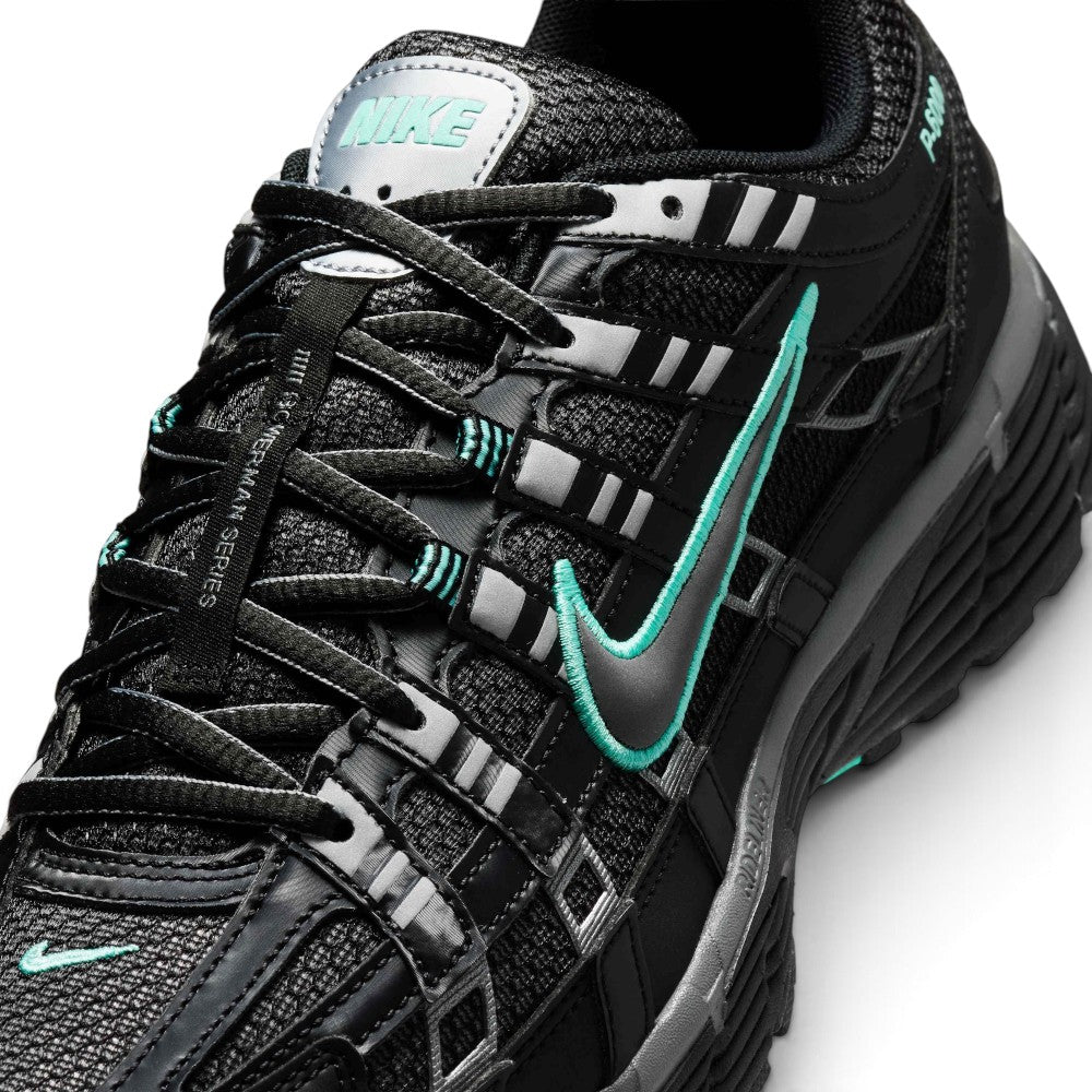 Focusing on the Breathable Open-Pore Black Mesh Toe Box, Metallic Cool Grey Cage Overlays, and Branded Tongue Webbing, demonstrating the upper airflow channels, structural containment boundaries, and refined finish as the stylish final detail.