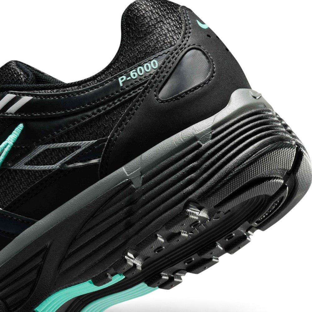 Highlighting the Sculpted Dual-Tone Foam Midsole Texture, Moulded Swoosh with Heavy-Density Hyper Turquoise Stitching, and Multi-Directional Rubber Tread, demonstrating the impact-absorbing foam depth and retro-tested tooling.