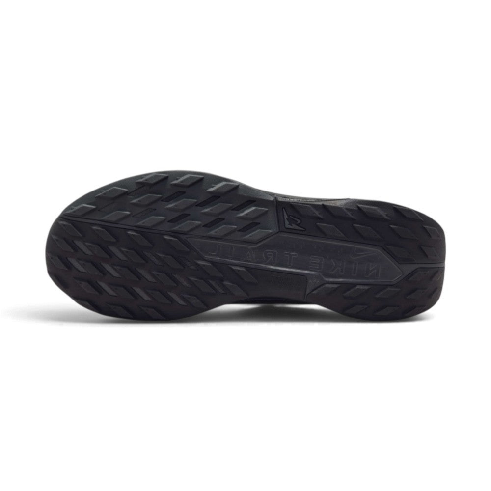 Full-length bottom profile showing the all-terrain rubber outsole, highlighting the multi-directional lug pattern engineered to provide optimal traction on wet and loose trail surfaces.