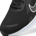 Details the high-definition micro-perforations across the mesh toe strike zone and the precision eyelet stitching.