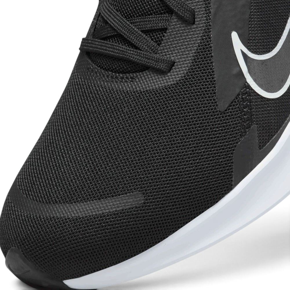 Details the high-definition micro-perforations across the mesh toe strike zone and the precision eyelet stitching.