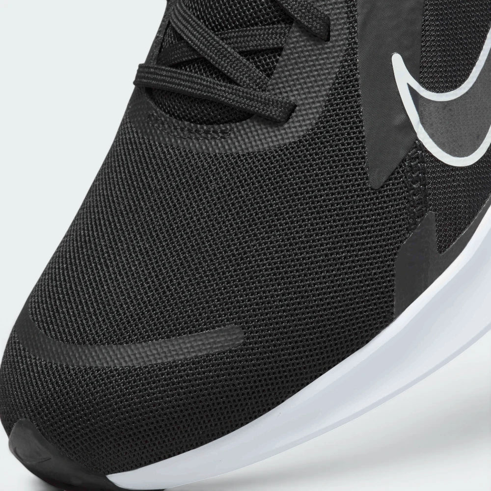 Details the high-definition micro-perforations across the mesh toe strike zone and the precision eyelet stitching.
