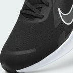 Details the high-definition micro-perforations across the mesh toe strike zone and the precision eyelet stitching.