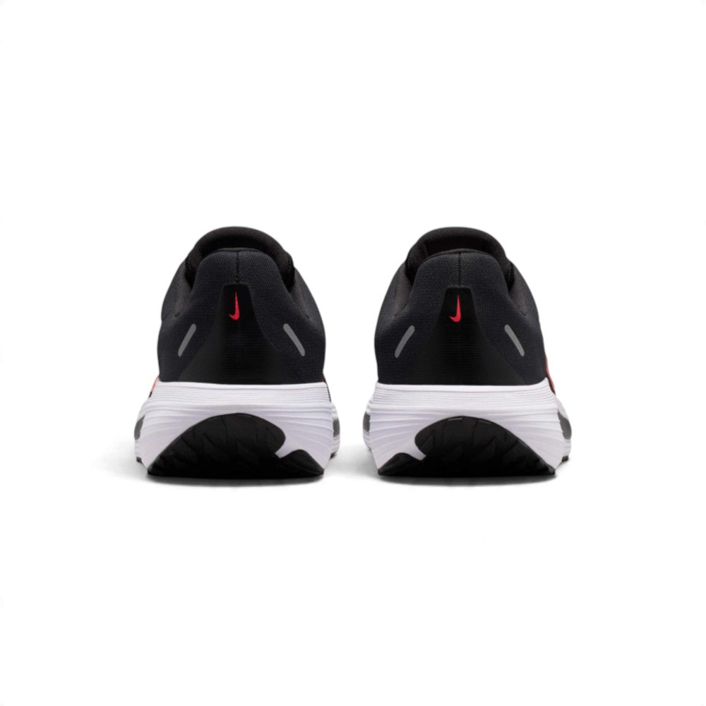 Rear view of the sneakers emphasizing the heel stability counter, reflective hit details, and the rear ground contact footprint.
