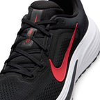 A close-up of a Nike running shoe in black and red with a white midsole, showing the side profile and lace area.