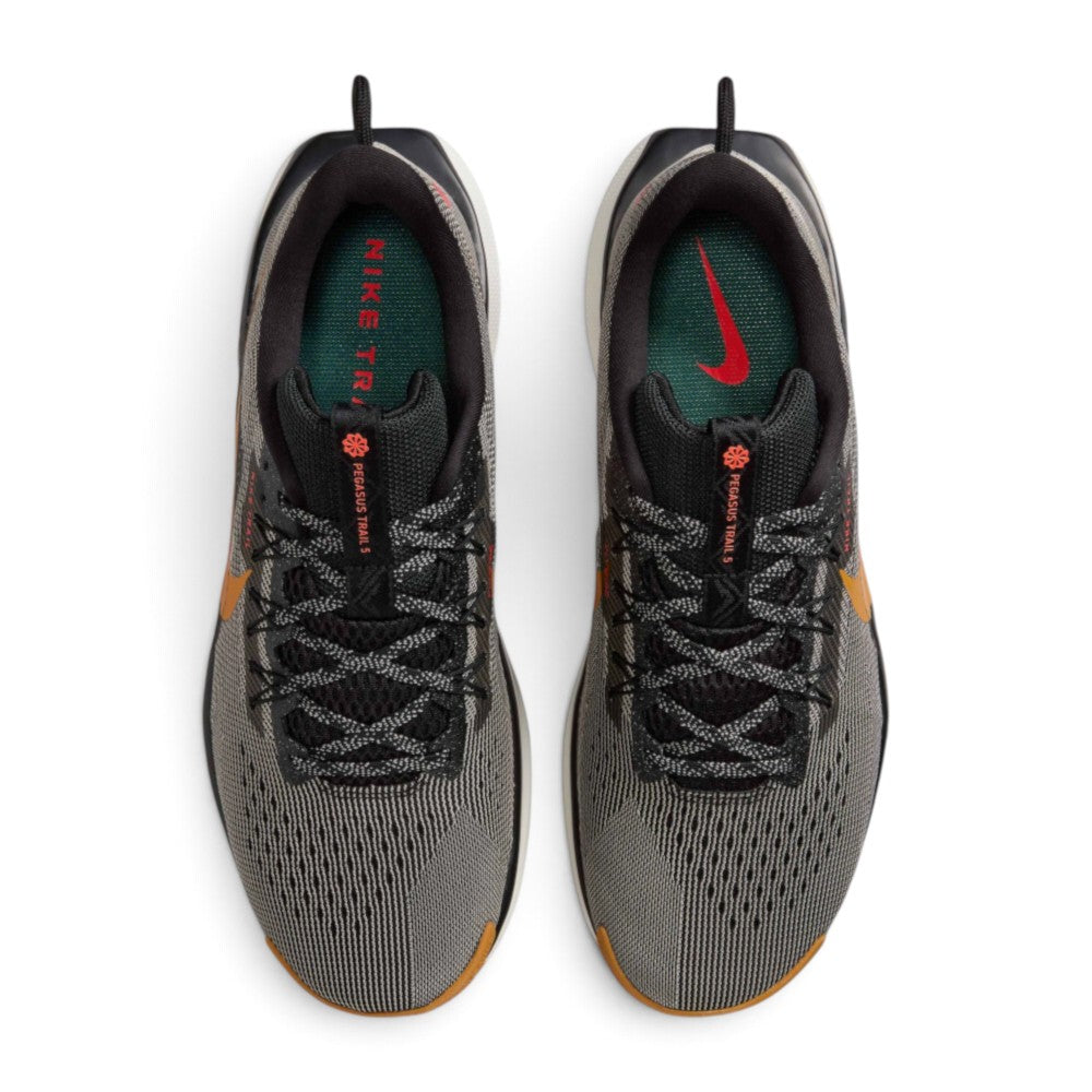 Focuses on the locked-in central lacing layout, displaying flat laces, open-hole mesh tongues with Nike Trail branding badges, padded ankle collars, and cushioned insoles.