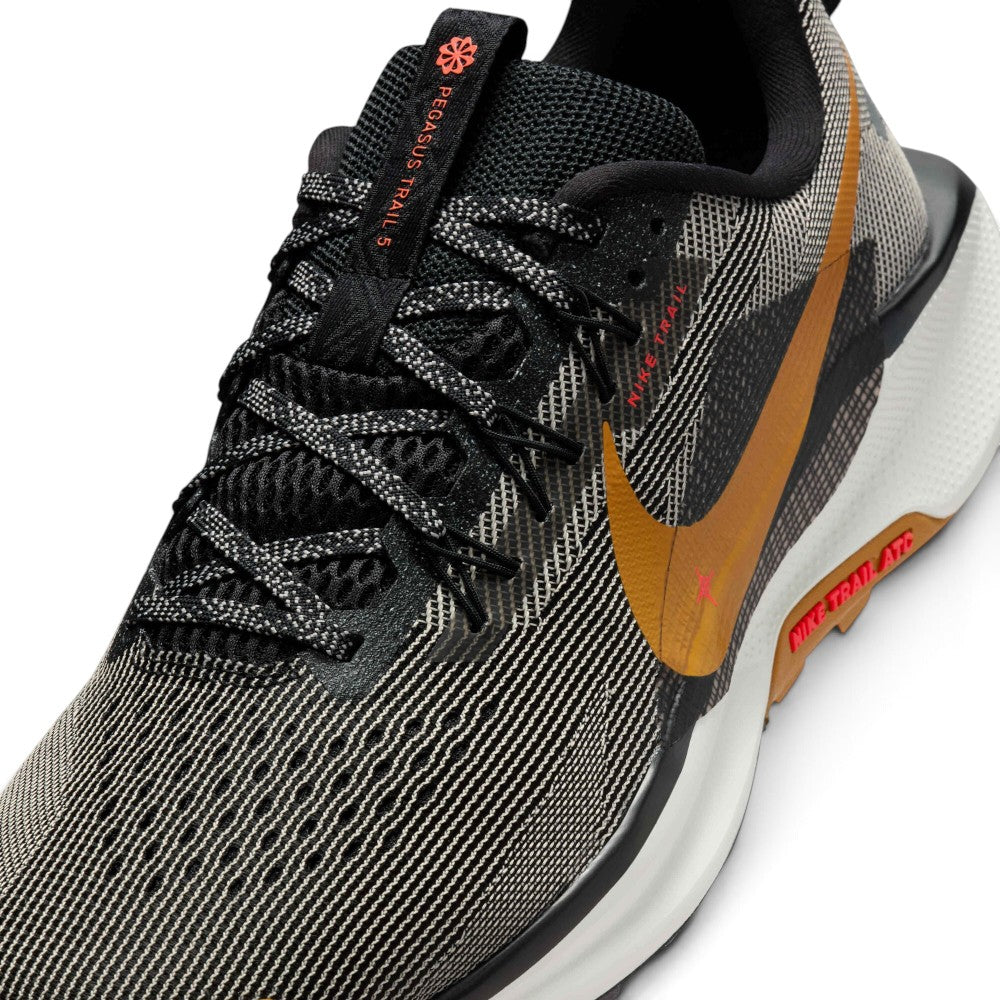 Details the micro-precision of the forefoot area, showing the open-hole mesh toe box, bonded protective synthetic toe cap, flat laces, and integrated Flywire cable eyelets.