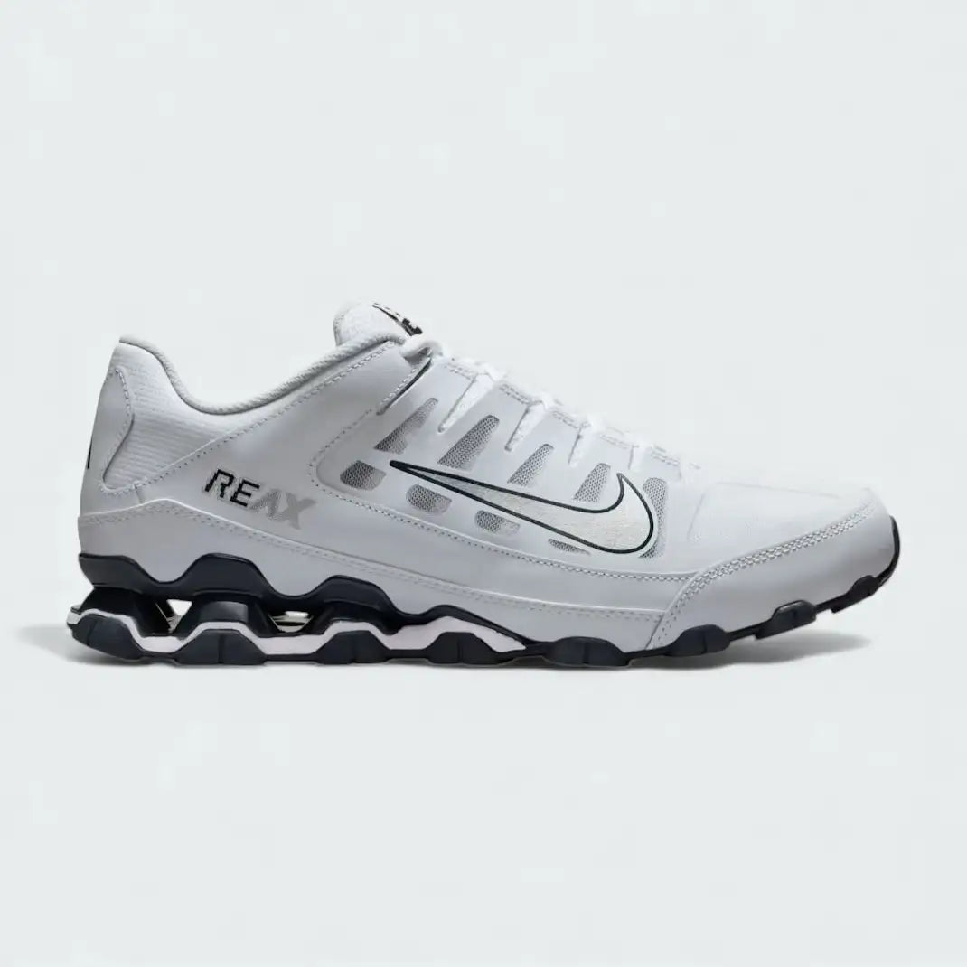 Nike Reax 8 Training Shoes Men's in white with metallic silver accents, side profile showing mesh upper, distinctive Reax cushioning pillars in the heel, and Nike Swoosh.