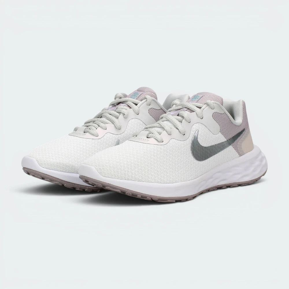 Emphasising the low-cut, athletic running stance of the trainers, highlighting the delicate color harmony of the white, silver, and soft ocean cube blue paneling.