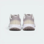 Focuses on the contoured shape of the padded low-cut collar, highlighting the seamless cream-grey heel counter overlay and the wide, stable footprint of the cushioning foam sole below.