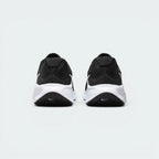 Focuses on the contoured shape of the padded ankle collar, highlighting the soft, pillowy Achilles puffs visible on the outer heel counter.