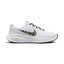 Side Profile Image: Studio lateral shot of the Nike Revolution 8 women's running shoes in white, black, and metallic gold, highlighting the breathable mesh upper, animal-print Swoosh, white foam midsole, and black rubber outsole.   
