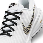 Zoom Looking at the Front of the Shoes and Laces: Macro focus on the fine-grained mesh toe box, black flat athletic laces, and the woven tongue label with black Nike branding.   