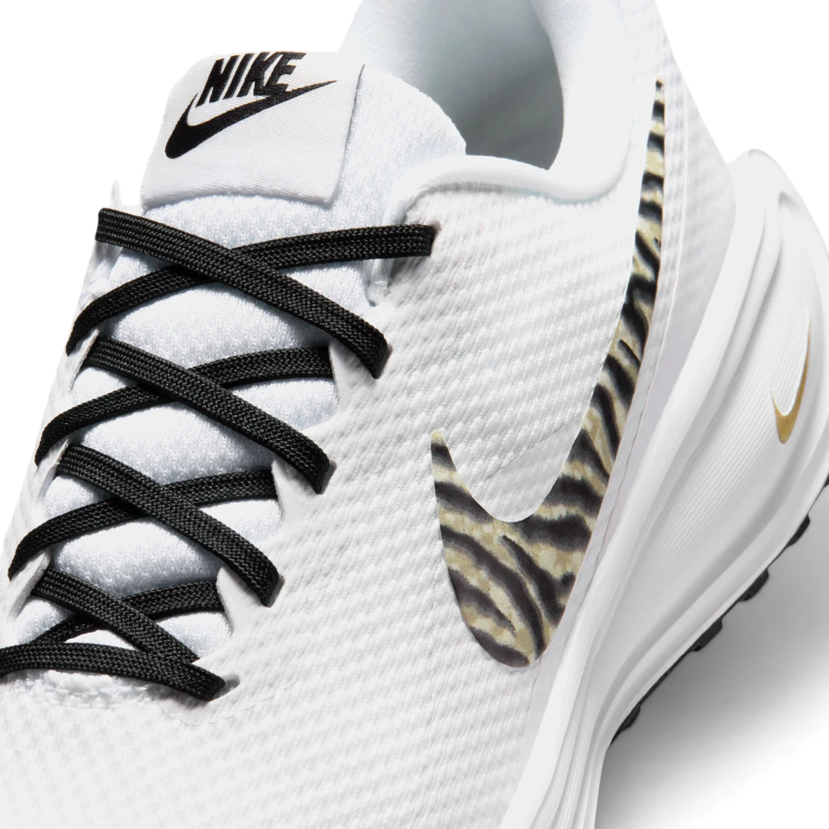 Zoom Looking at the Front of the Shoes and Laces: Macro focus on the fine-grained mesh toe box, black flat athletic laces, and the woven tongue label with black Nike branding.   