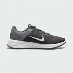 Nike Revolution 6 Next Nature Men's running trainers in iron grey with a white midsole, side profile showing mesh upper, soft foam cushioning, and Nike Swoosh.
