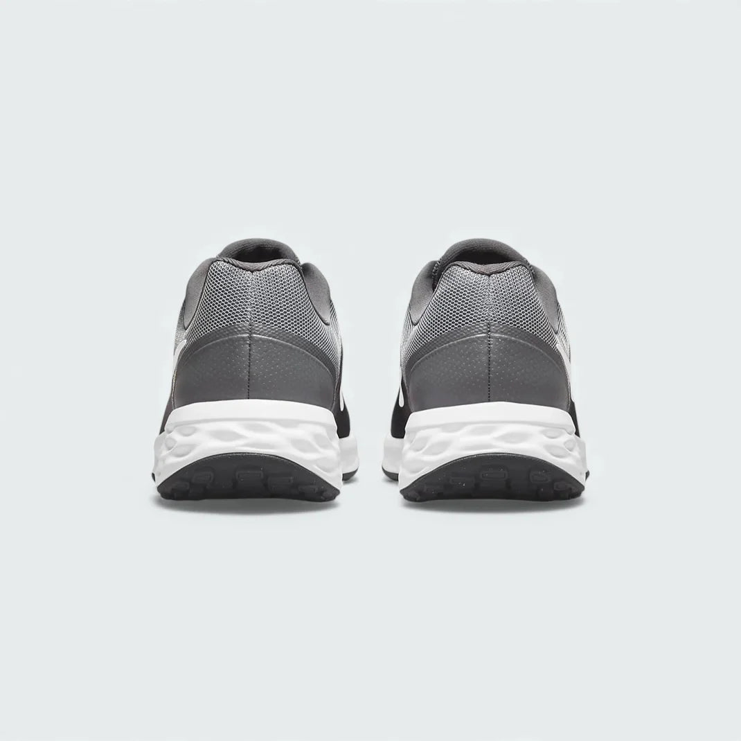 Rear view of the Nike Revolution 6 Next Nature Men's grey running trainers, focusing on the structured heel and subtle branding.