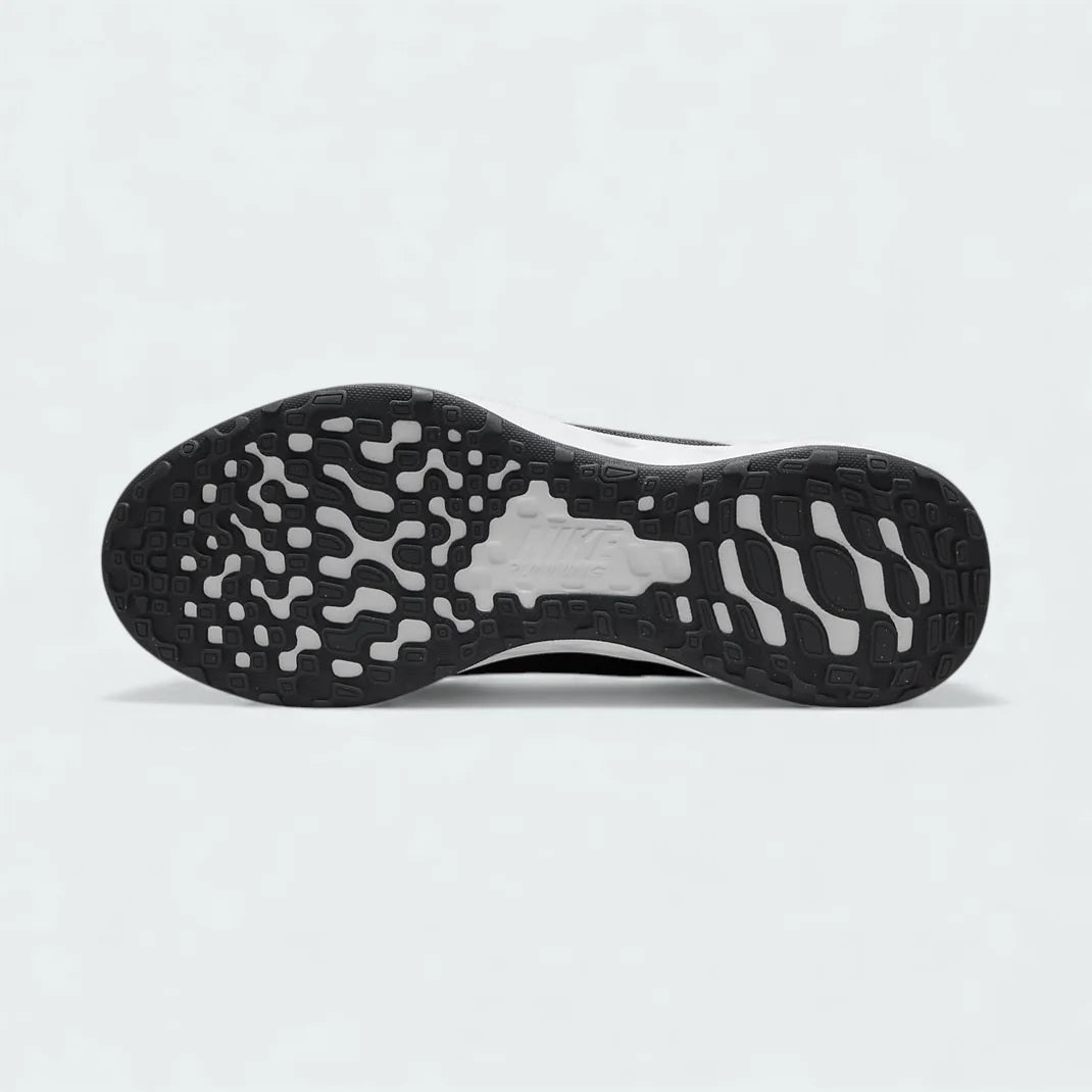 View of the outsole of the Nike Revolution 6 Next Nature Men's grey trainers, showing the durable rubber tread pattern with flex grooves for traction.