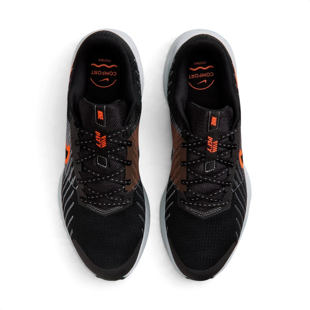 Overhead view of both running shoes showing the breathable black mesh forefeet, central lacing systems, and branded insoles featuring "COMFORT" footbed text.