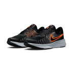 Three-quarter forward angle showcasing both sneakers side by side, highlighting their streamlined athletic silhouette and bold black-and-orange colour blocking.