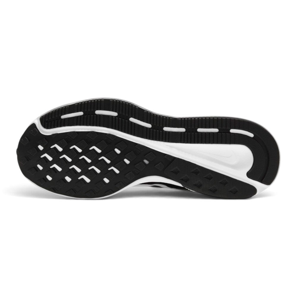 Displays the full-length black rubber outsole, showcasing the multi-directional traction pattern, flex grooves for natural toe-off, and central transition channels.