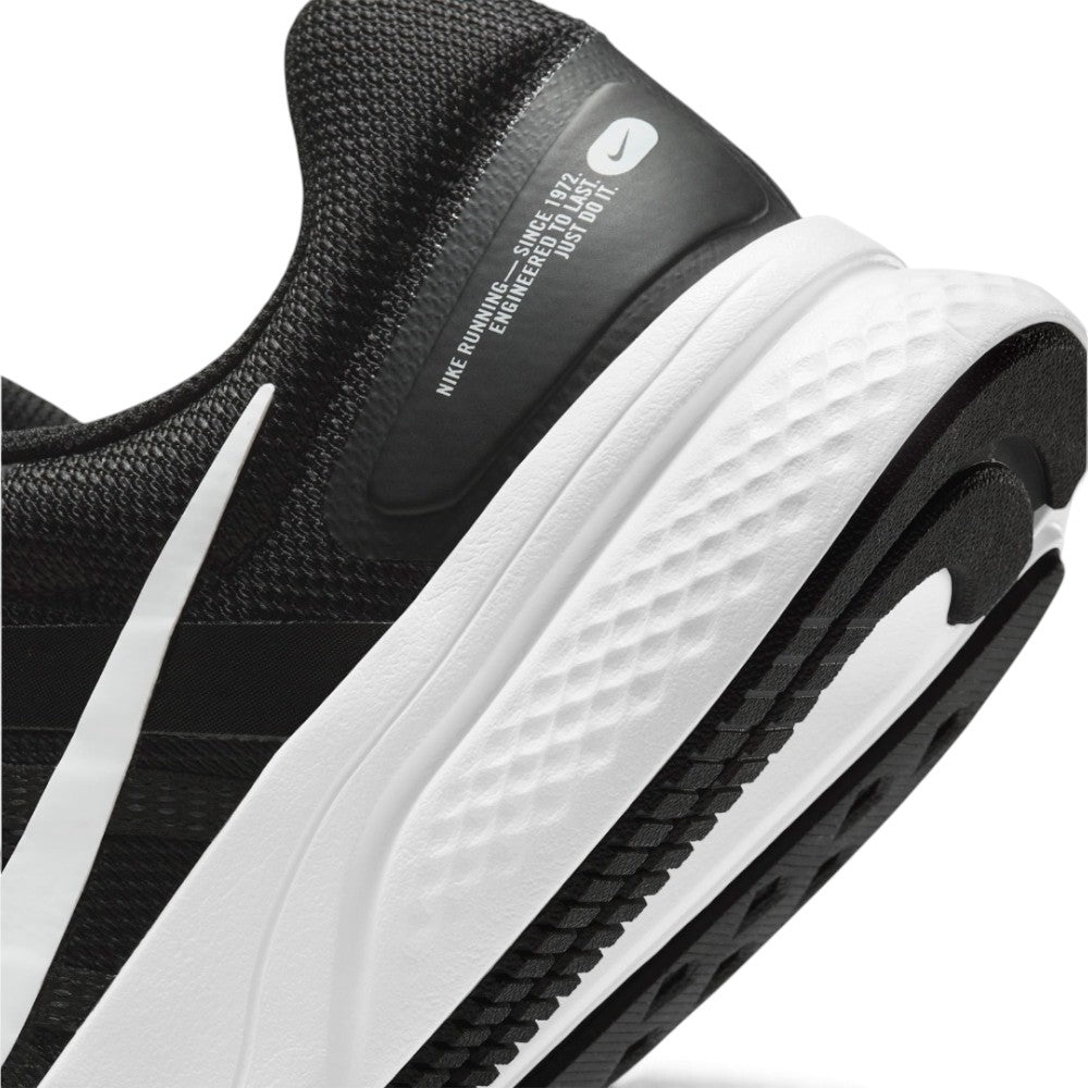 Highlights the "unreal" clean finish where the high-stack white foam midsole meets the durable black rubber outsole and the trailing tail of the white Swoosh.