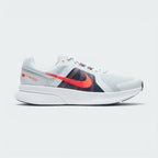 Highlights the high-velocity sweep of the contrasting Chile Red Nike Swoosh, showing the professional, multi-textured grey mesh upper, the Obsidian navy midfoot paneling, and the clean white foam midsole wall.
