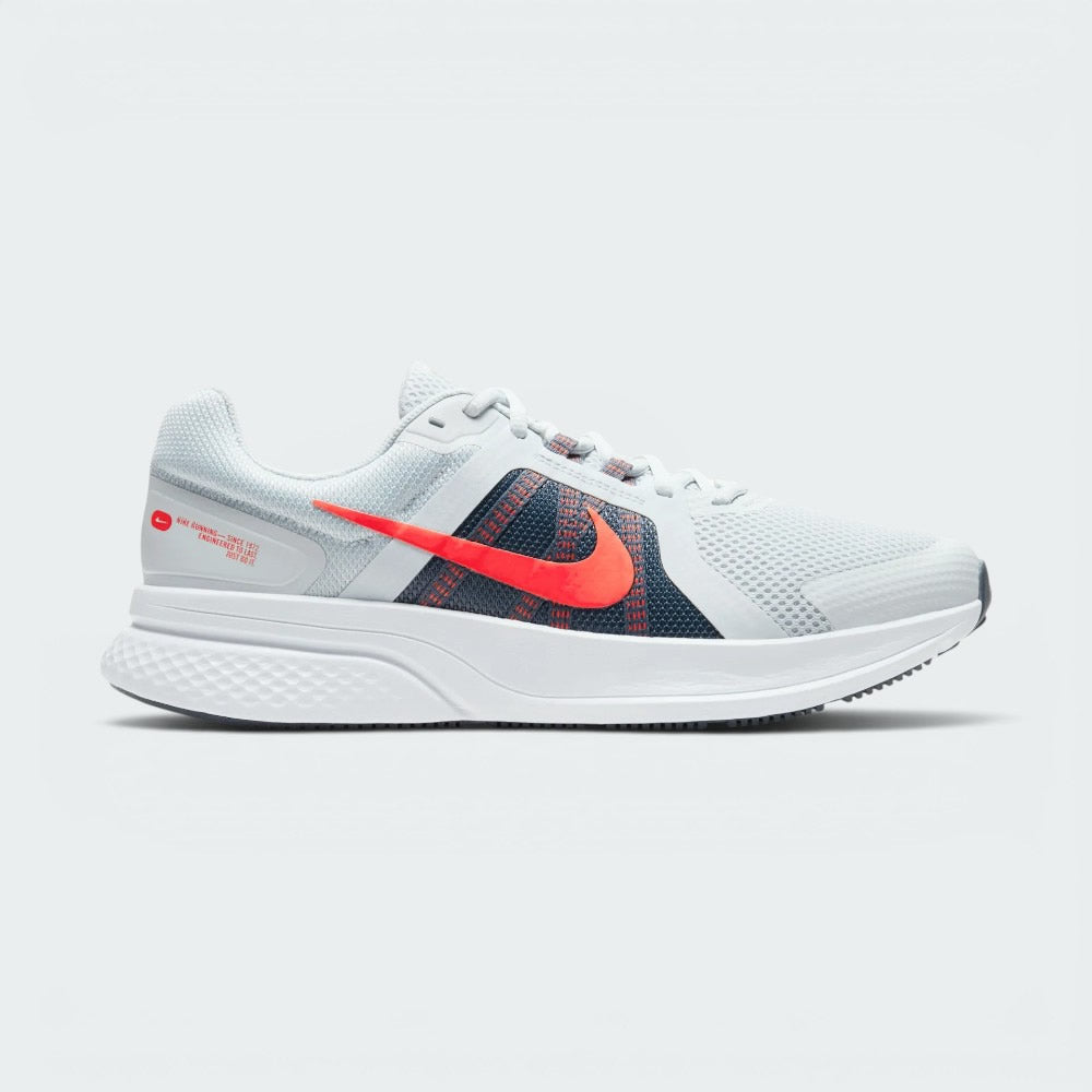 Highlights the high-velocity sweep of the contrasting Chile Red Nike Swoosh, showing the professional, multi-textured grey mesh upper, the Obsidian navy midfoot paneling, and the clean white foam midsole wall.