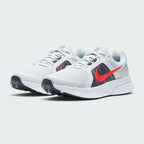 Emphasising the low-slung, forward-leaning running stance and the professional harmony of the red, grey, and navy contrast panels.